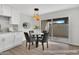 Charming dining area with modern light fixture and sliding glass doors to an outdoor patio at 9036 N 51St Ln, Glendale, AZ 85302