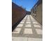 A long and well maintained backyard pathway constructed with stones and gravel at 9302 W Georgia Ave, Glendale, AZ 85305