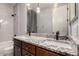 Bathroom with double sinks, granite countertop, and modern lighting at 9302 W Georgia Ave, Glendale, AZ 85305