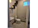 Charming powder room with a pedestal sink, decorative shelves, and modern hexagonal tile flooring at 9302 W Georgia Ave, Glendale, AZ 85305