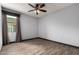 Bedroom with wood-look floors, a ceiling fan, and a large window at 9302 W Georgia Ave, Glendale, AZ 85305