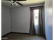 A calming bedroom with a ceiling fan, a decorative window cornice, and hardwood floors at 9302 W Georgia Ave, Glendale, AZ 85305