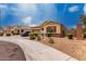 Lovely single-story home featuring desert landscaping, stone accents, and a two-car garage at 9302 W Georgia Ave, Glendale, AZ 85305