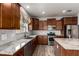 Gourmet kitchen with granite countertops, stainless steel appliances, and ample cabinet space at 9302 W Georgia Ave, Glendale, AZ 85305