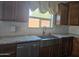 Kitchen featuring new granite countertops, stainless steel appliances, and a window with valance at 9302 W Georgia Ave, Glendale, AZ 85305