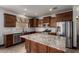 Gourmet kitchen with granite countertops, stainless steel appliances, and ample cabinet space at 9302 W Georgia Ave, Glendale, AZ 85305
