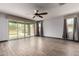 Spacious living room featuring tile flooring, large windows, and a sliding glass door at 9302 W Georgia Ave, Glendale, AZ 85305
