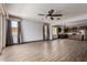 Open-concept living room with tile flooring, large windows, and seamless flow to the kitchen at 9302 W Georgia Ave, Glendale, AZ 85305