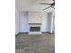 Cozy living room features an electric fireplace with stacked stone and wood-look tile flooring at 9302 W Georgia Ave, Glendale, AZ 85305