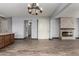 Open-concept living area featuring tile floors, modern lighting, and a stylish fireplace at 9302 W Georgia Ave, Glendale, AZ 85305
