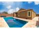 Stunning pool with beautiful water and travertine decking near a well-maintained home at 9302 W Georgia Ave, Glendale, AZ 85305
