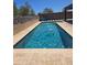Stunning backyard pool with a sun shelf, water features and a meticulously landscaped yard at 9302 W Georgia Ave, Glendale, AZ 85305