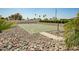 Community basketball court surrounded by rock landscaping and lush palm trees at 9431 E Coralbell Ave # 60, Mesa, AZ 85208