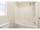 Bright bathroom with a tub and shower combo features white tile and a convenient shower head at 9431 E Coralbell Ave # 60, Mesa, AZ 85208