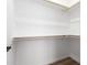 Walk-in closet offers ample space with wooden rails, providing organized storage for clothing and accessories at 9431 E Coralbell Ave # 60, Mesa, AZ 85208