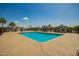 Community pool featuring poolside gazebos and lush palm trees around the exterior at 9431 E Coralbell Ave # 60, Mesa, AZ 85208