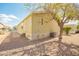 Side view of a single-story home with gravel landscaping and mature tree for shade at 9431 E Coralbell Ave # 60, Mesa, AZ 85208