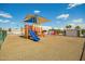 Community playground featuring modern play structures, shade canopies, and rubber flooring at 9431 E Coralbell Ave # 60, Mesa, AZ 85208