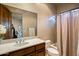 Well-lit bathroom features a tiled shower/tub combo, a wood vanity, and an open view to the bedroom at 9560 E Preserve Way, Scottsdale, AZ 85262