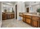 Elegant bathroom with dual sinks, wooden cabinetry, stylish mirrors, and neutral color palette at 9560 E Preserve Way, Scottsdale, AZ 85262