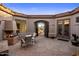 Charming courtyard featuring a fireplace, comfortable seating, and decorative elements creating an inviting outdoor space at 9560 E Preserve Way, Scottsdale, AZ 85262