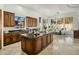 Spacious kitchen with granite countertops, custom cabinets, and a center island, perfect for cooking and entertaining at 9560 E Preserve Way, Scottsdale, AZ 85262
