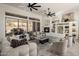 Bright living room with large windows, fireplace, built-in shelving, and modern ceiling fans at 9560 E Preserve Way, Scottsdale, AZ 85262