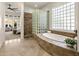Luxurious main bathroom featuring a soaking tub, glass block shower, and elegant design details at 9560 E Preserve Way, Scottsdale, AZ 85262