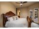 Comfortable bedroom with wooden bed frame, ceiling fan, neutral tones, and access to outdoor patio at 9560 E Preserve Way, Scottsdale, AZ 85262