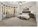 Spacious main bedroom with large windows, plush bedding, sitting area, and serene desert views at 9560 E Preserve Way, Scottsdale, AZ 85262
