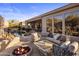 Inviting outdoor patio with a fire pit, comfortable seating, and views of the pool and desert landscape at 9560 E Preserve Way, Scottsdale, AZ 85262
