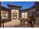 Spacious outdoor patio has a brick fireplace and comfortable seating, perfect for relaxing or entertaining at 9560 E Preserve Way, Scottsdale, AZ 85262
