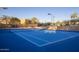 Bright blue tennis court with pristine white lines and a well-maintained net at 9560 E Preserve Way, Scottsdale, AZ 85262
