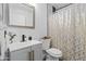 Bathroom with modern vanity, golden shower curtain, and neutral color palette at 974 E Palomino Way, San Tan Valley, AZ 85143