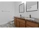 Bathroom featuring double sinks with granite counters and modern fixtures at 974 E Palomino Way, San Tan Valley, AZ 85143