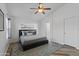 Bright bedroom featuring modern decor, wood-look floors, a ceiling fan, and a comfortable-looking bed at 974 E Palomino Way, San Tan Valley, AZ 85143