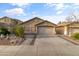 Charming single-story home with a desert landscape front yard and attached two-car garage at 974 E Palomino Way, San Tan Valley, AZ 85143