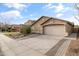 Lovely single-story house boasts desert landscaping, a spacious driveway, and an attached two-car garage at 974 E Palomino Way, San Tan Valley, AZ 85143