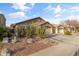 Desert landscaping with a long driveway leads to the two-car garage of this single-story home at 974 E Palomino Way, San Tan Valley, AZ 85143