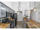 Well-lit kitchen with granite countertops, stainless steel appliances, and modern lighting, creating an inviting space at 974 E Palomino Way, San Tan Valley, AZ 85143