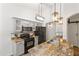 Modern kitchen featuring granite counters, stainless steel appliances, updated cabinets, and stylish pendant lighting at 974 E Palomino Way, San Tan Valley, AZ 85143