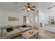 Open living area with comfortable sofa, stylish decor, and seamlessly connects to the kitchen for easy entertaining at 974 E Palomino Way, San Tan Valley, AZ 85143