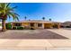 Charming single-story home featuring desert landscaping and a covered carport, creating an inviting curb appeal at 9746 W Edward Dr, Sun City, AZ 85351