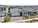 An aerial view of a charming house with well-manicured landscaping and a two-car garage in a Gathering-friendly neighborhood at 9821 E Supernova Dr, Mesa, AZ 85212
