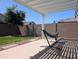 Relaxing backyard featuring a hammock under a pergola and ample green space at 9821 E Supernova Dr, Mesa, AZ 85212