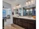 This bathroom has dual vanities, complemented by a stylishly tiled walk-in shower at 9821 E Supernova Dr, Mesa, AZ 85212