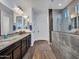 This bathroom features a stylish walk-in shower and a spacious granite countertop at 9821 E Supernova Dr, Mesa, AZ 85212
