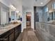 This bathroom features a stylish walk-in shower and a spacious granite countertop at 9821 E Supernova Dr, Mesa, AZ 85212