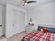 Cozy bedroom featuring carpet flooring, a ceiling fan, and a closet with white sliding doors at 9821 E Supernova Dr, Mesa, AZ 85212