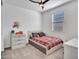 Well-lit bedroom with a neutral color scheme, carpet flooring, and a ceiling fan at 9821 E Supernova Dr, Mesa, AZ 85212